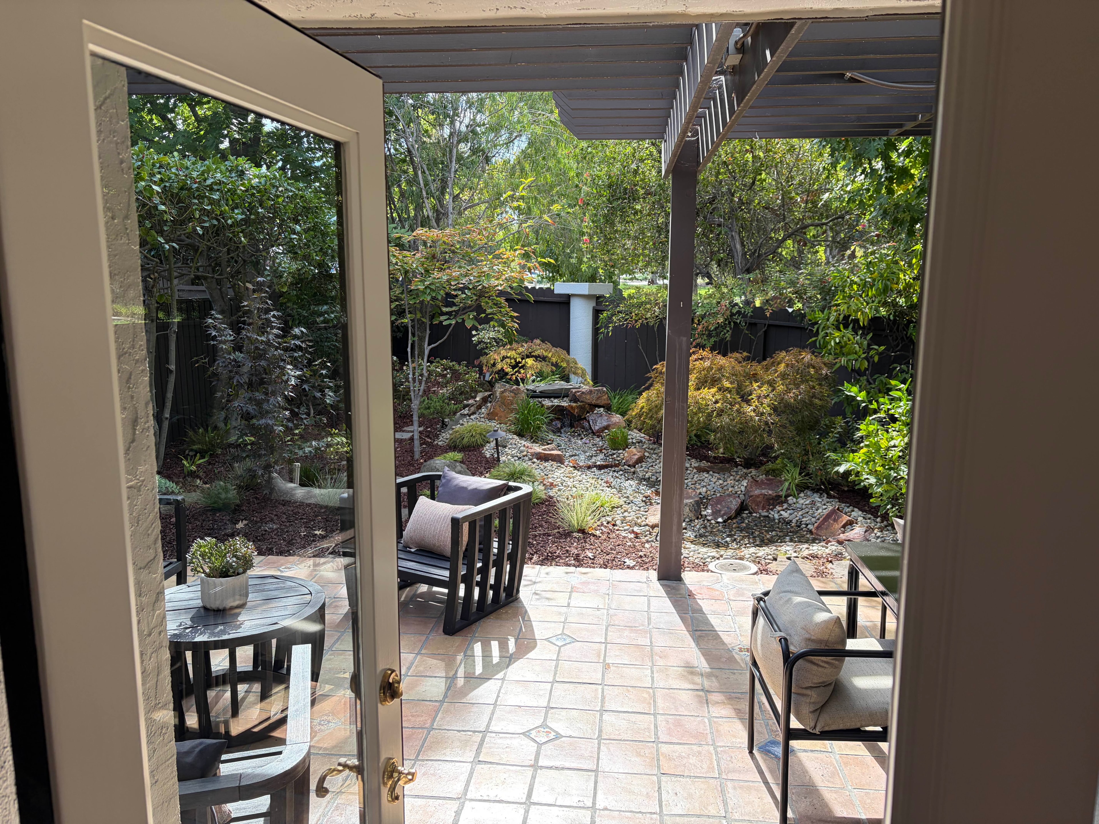 Serene back patio with cascading waterfall garden